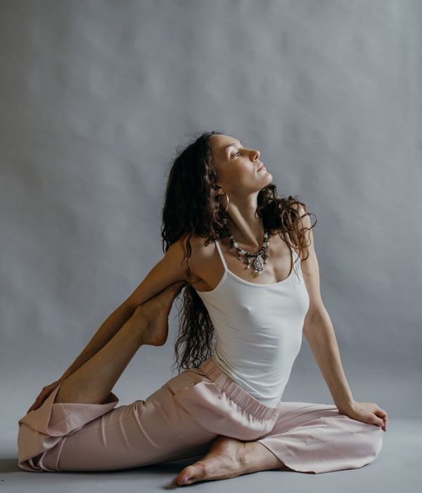 Woman in a graceful yoga pose promoting flexibility and well-being.